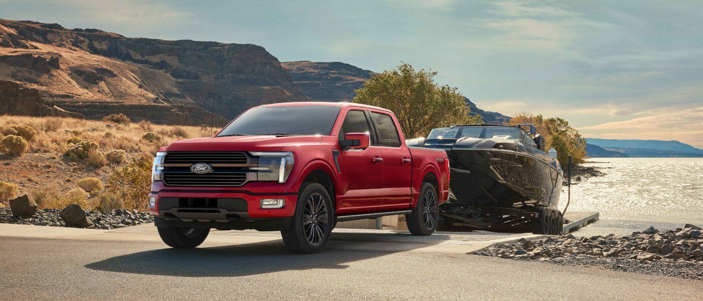 2024 Ford F-150 towing a large boat in the mountain range