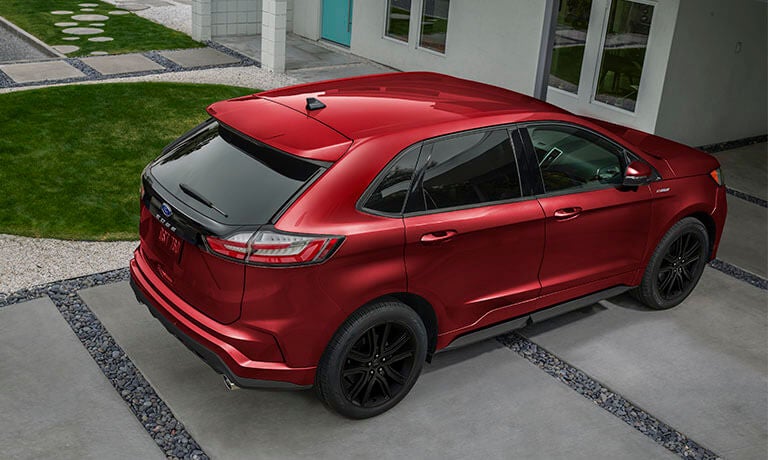 2024 Ford Edge in red exterior parked outside a home